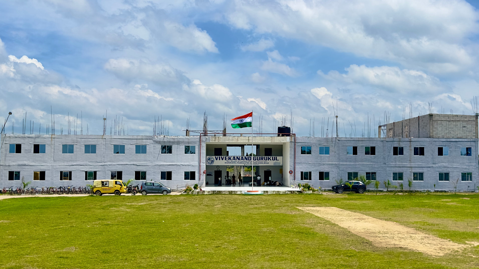 The Vivekanand Gurukul campus building in Badimath, Parwalpur, Nalanda, with the national flag flying above the main entrance